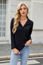 Black collared blouse with wave-effect pleating and long sleeves
