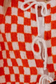 Orange and white checkered knit cardigan with tie-front detail