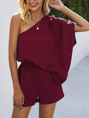 Burgundy playsuit with one-shoulder neckline, elastic waist, and short bottoms