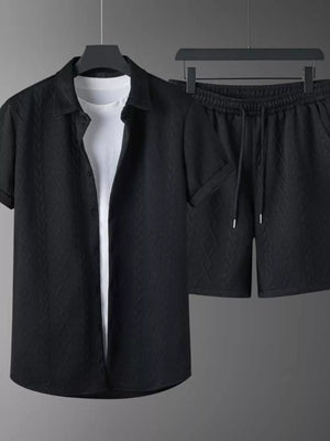 Black knit polo shirt with textured pattern and matching shorts with drawstring.
