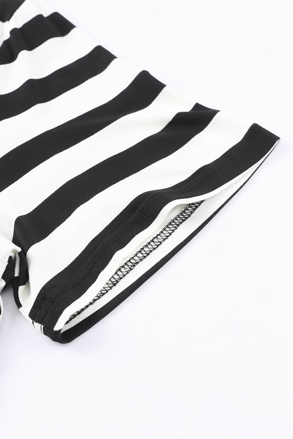 Black and white striped jersey maxi dress detail showing sleeve hem and seam.