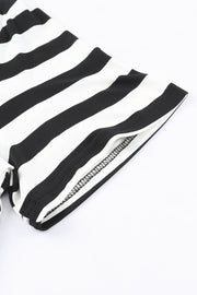Black and white striped jersey maxi dress detail showing sleeve hem and seam.