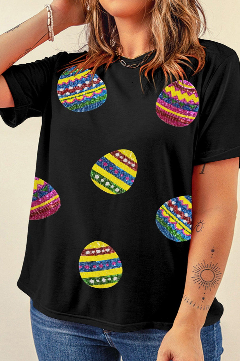 Black crewneck tee with colorful sequin Easter egg print