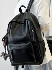 Chic black pu leather medium backpack with front pockets and zipper details.