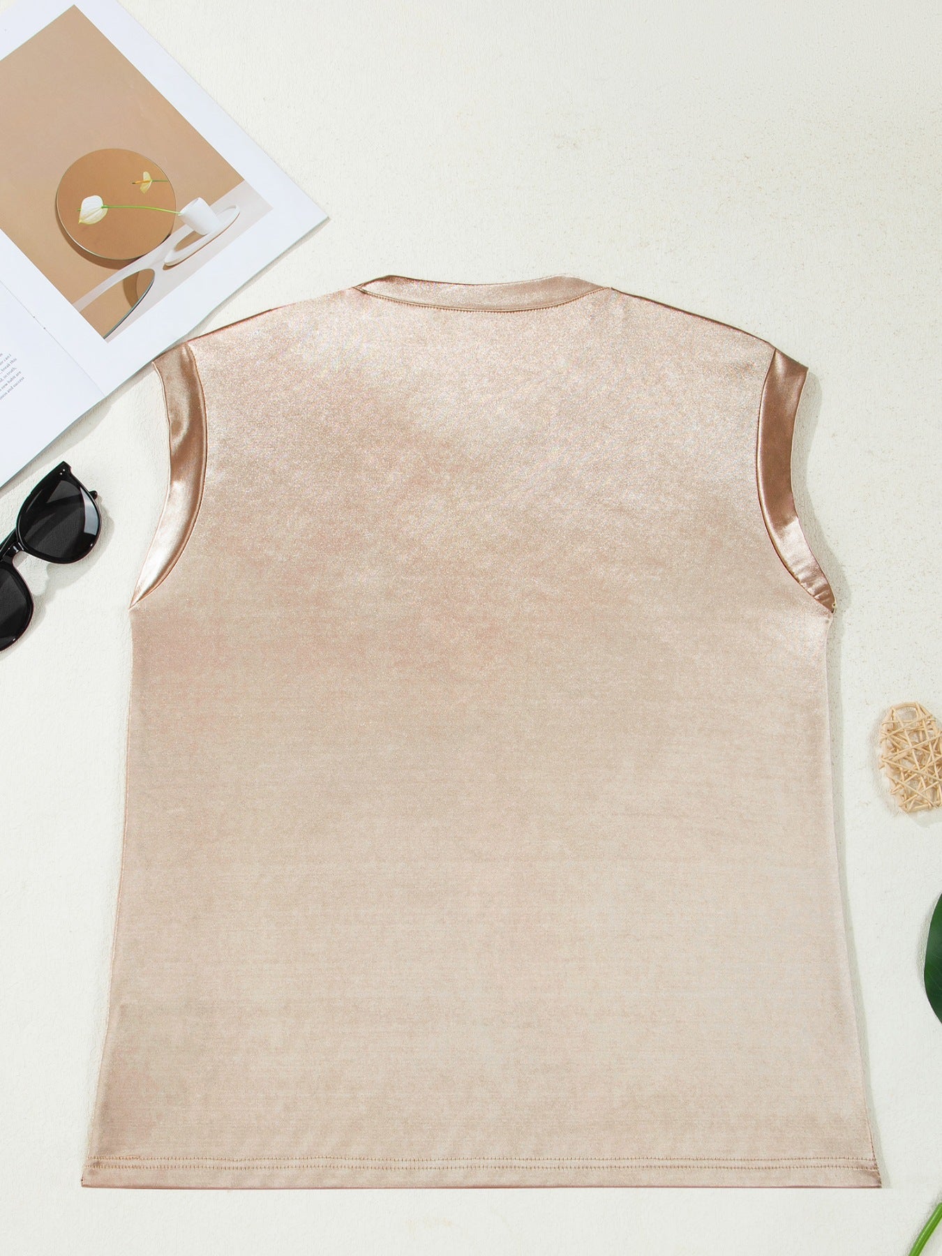 Sleeveless champagne metallic tank top with satin trim.