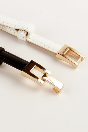 Geometric buckle leather belts in black and white with gold alloy hardware.
