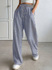 Blue and white striped wide-leg trousers with drawstring waist and pockets.