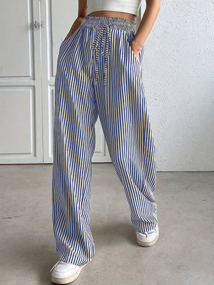 Blue and white striped wide-leg trousers with drawstring waist and pockets.