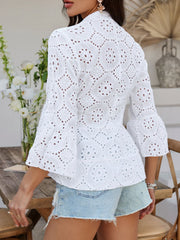 White eyelet embroidered peplum blouse with ruffled bell sleeves and buttoned front.