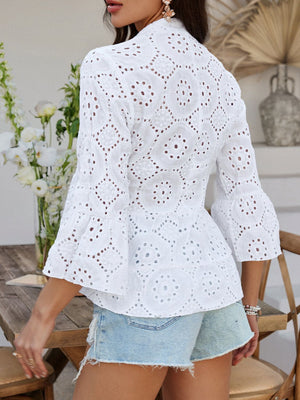 White eyelet embroidered peplum blouse with ruffled bell sleeves and buttoned front.