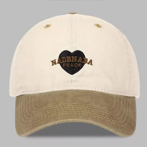 Vintage-washed baseball cap in tan and cream with embroidered heart detail.
