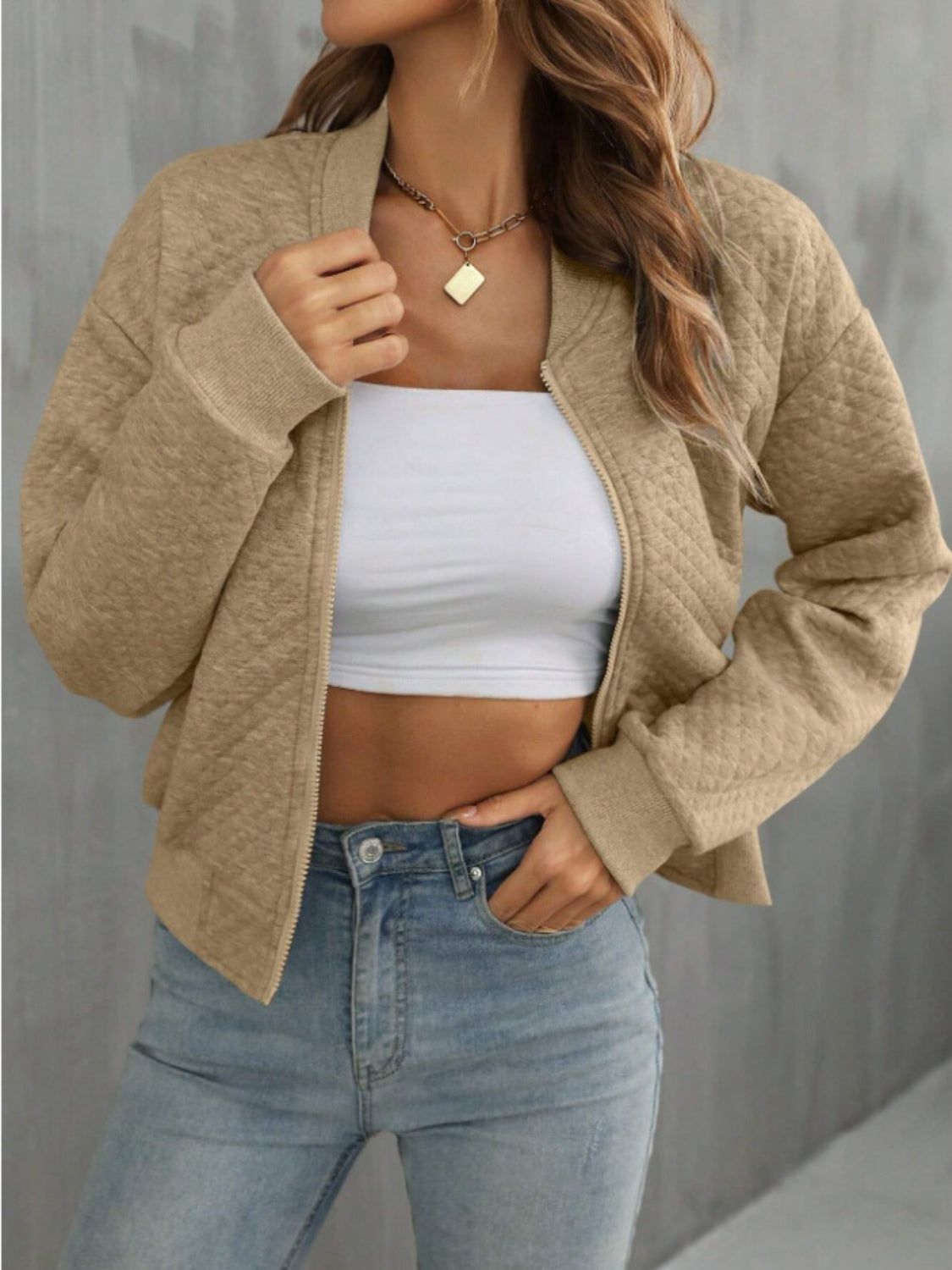 Diamond quilted bomber jacket in camel with zip front and ribbed cuffs.