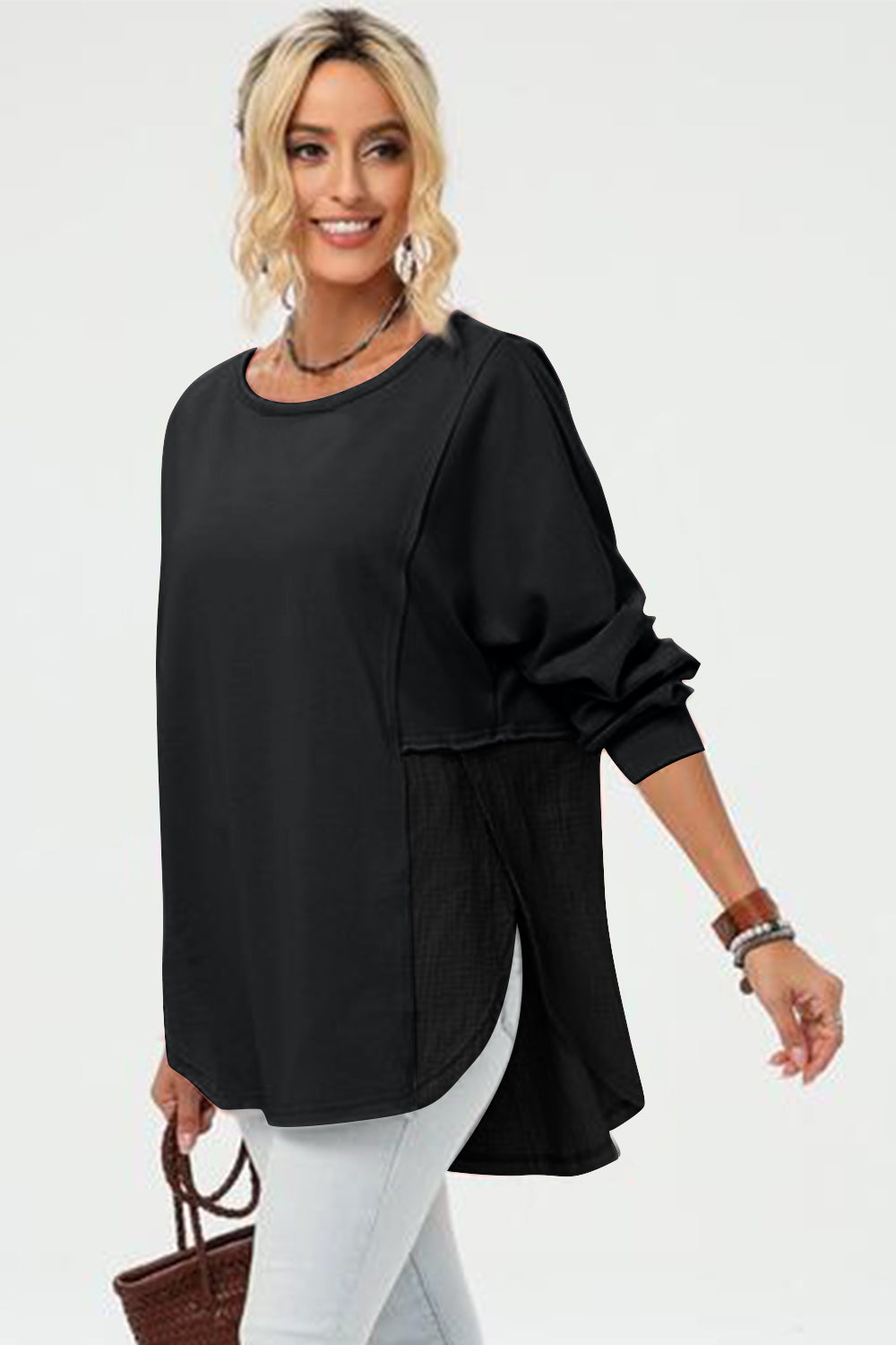 Black split-panel sweatshirt with asymmetric hemline and textured side panels.