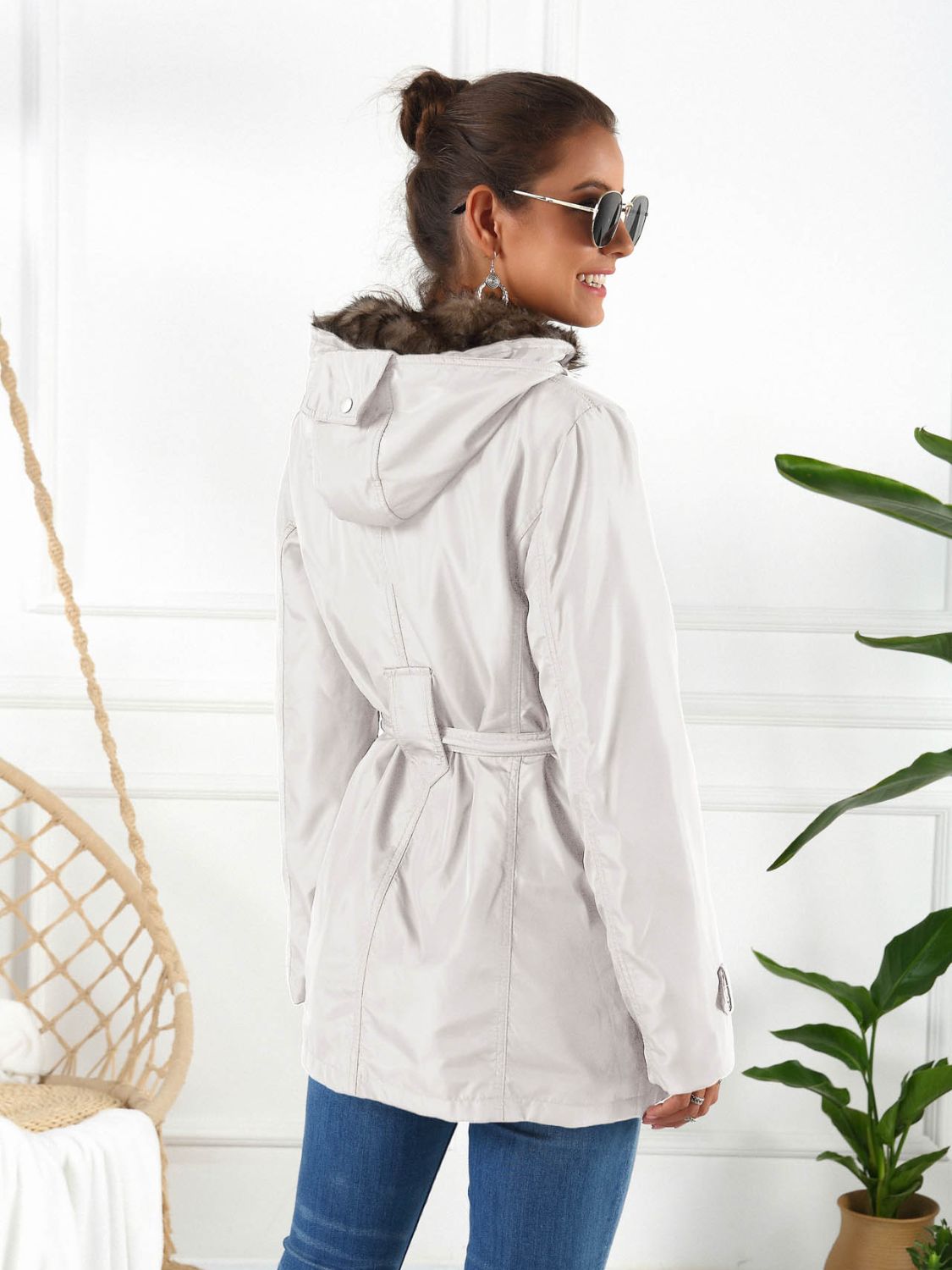 Belted utility parka in white with faux fur hood trim and a cinched waist.