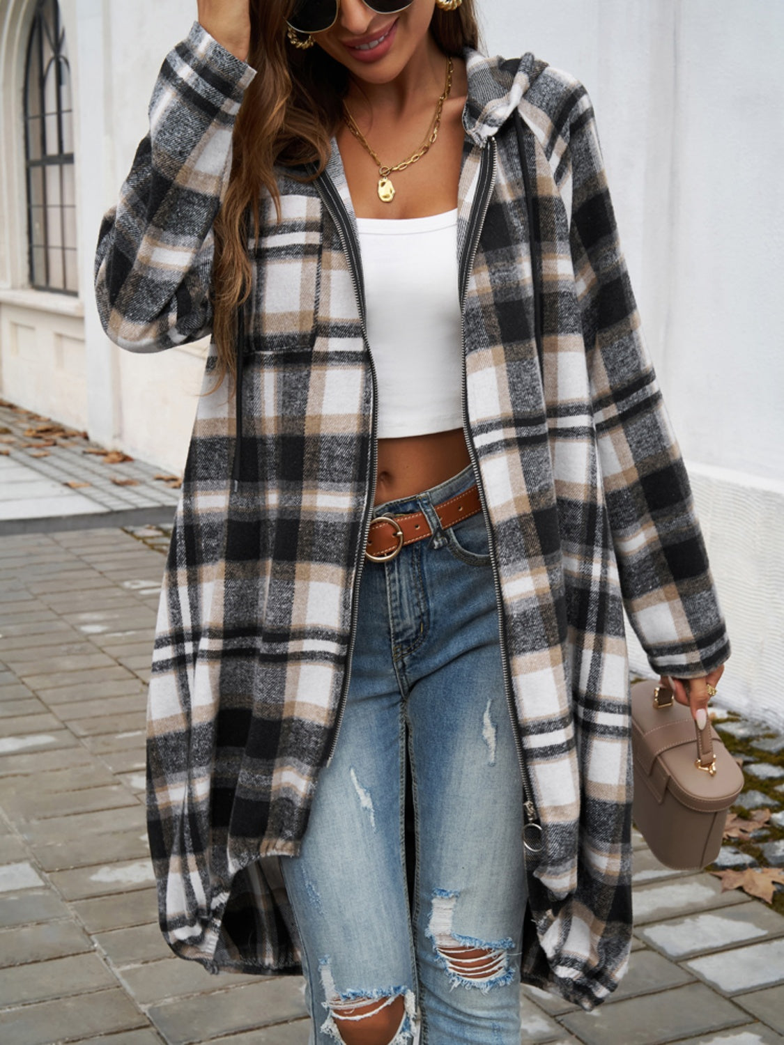 Draped plaid cocoon hoodie jacket in black, brown, and white plaid with a zip front and hood.