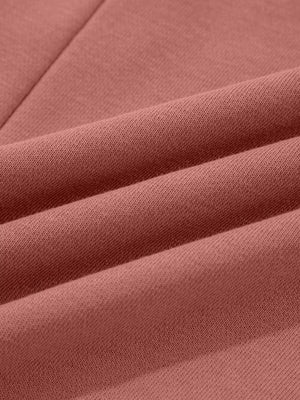 Dusty pink sweatshirt with exposed seam detail and textured fabric.