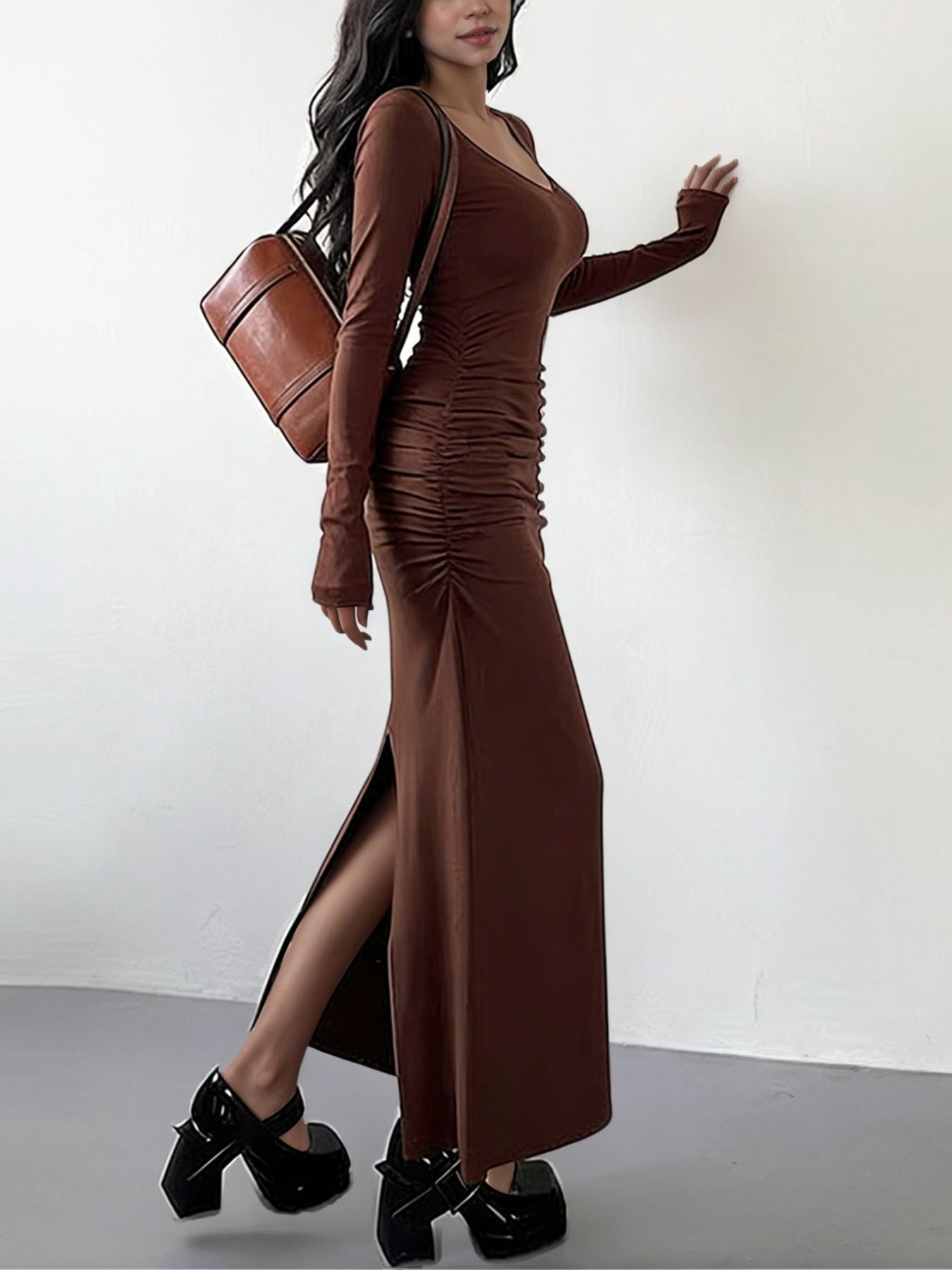 Brown ruched long-sleeve bodycon maxi dress with a thigh-high slit.
