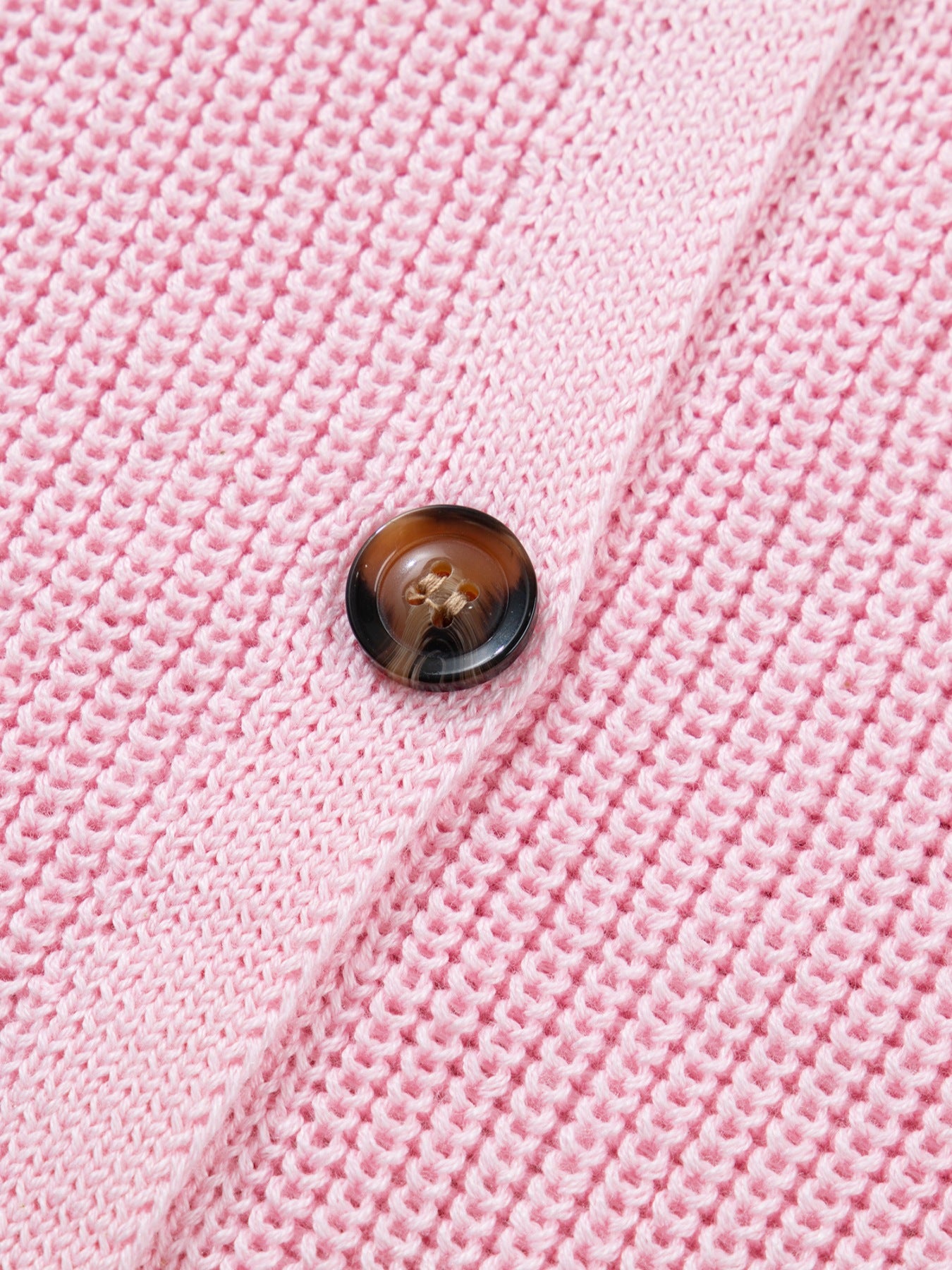 Pink acrylic button front sweater vest with V-neck detail.