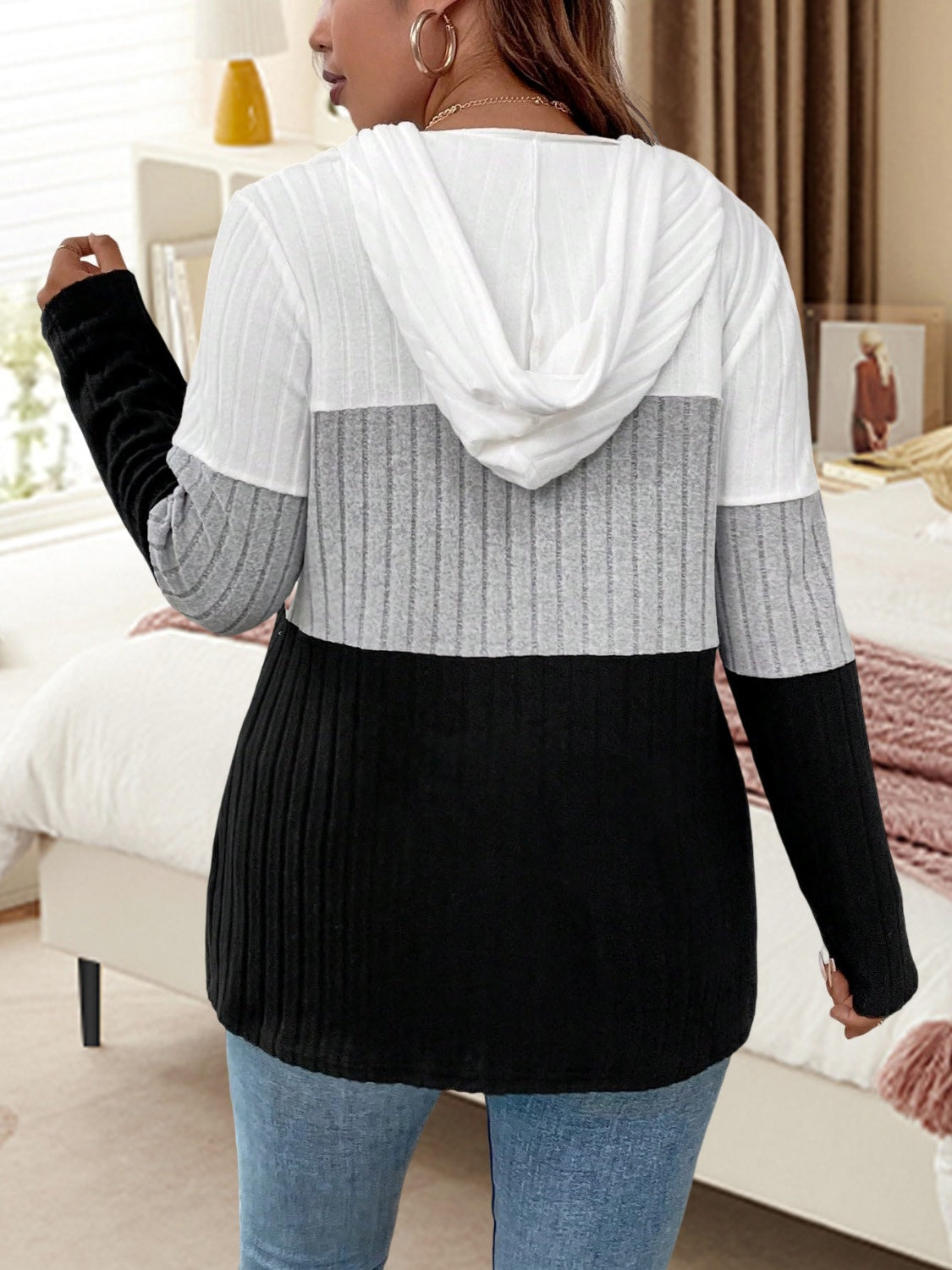 Ribbed colorblock hooded pullover in white, gray, and black with long sleeves.