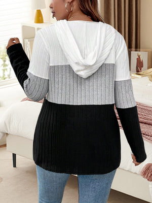 Ribbed colorblock hooded pullover in white, gray, and black with long sleeves.