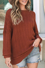 Textured diamond knit relaxed fit sweater in rust acrylic with a boat neck and long sleeves.