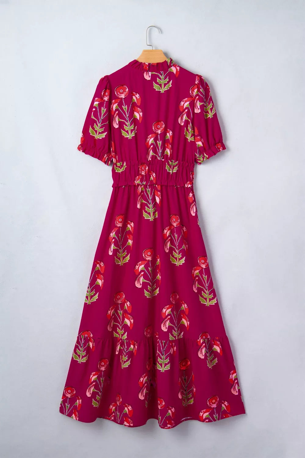 Charming floral tiered midi dress with ruffled neckline and sleeves, smocked waist, and cotton fabric.