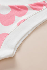 Floral print sleeveless top in blush pink and white with V-neck detail.