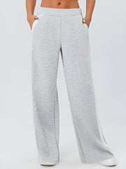 Light gray palazzo trousers with contrast white side panels and textured fabric.