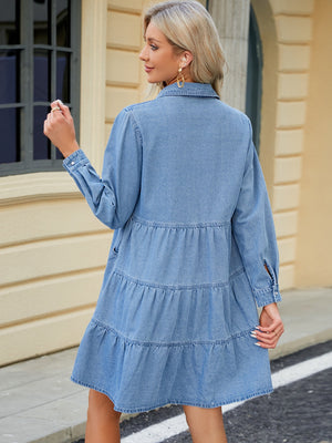 Tiered denim shirtdress in medium wash with buttoned cuffs and gathered tiers.