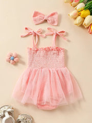 Pink smocked baby bodysuit with tulle skirt and matching headband.