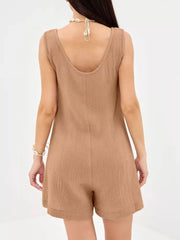 Khaki crinkled cotton sleeveless romper with shell necklace detail.