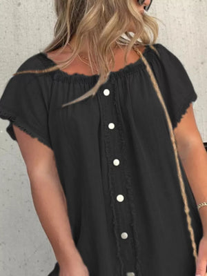 Black off-shoulder denim dress with frayed hem and button front detail.