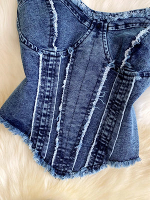 Denim cami top with raw hem and vertical seam details.