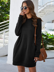 Black long sleeve sweatshirt dress with crew neck and slant pockets.