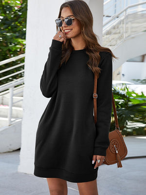 Black long sleeve sweatshirt dress with crew neck and slant pockets.
