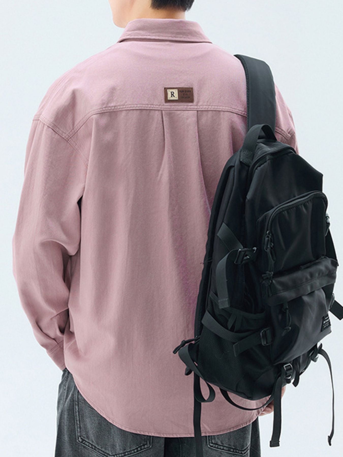 Men's pink cotton casual button-up shirt with back pleats and a leather patch detail.