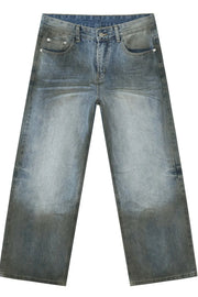 Pocketed high rise slouchy denim jeans in a faded medium wash with a relaxed fit.