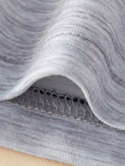 Close-up of grey marled cotton fabric with visible stitching detail on a baby outfit.