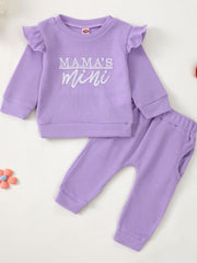 Purple waffle knit toddler top with ruffled sleeves and "Mama's Mini" graphic, and matching pants.