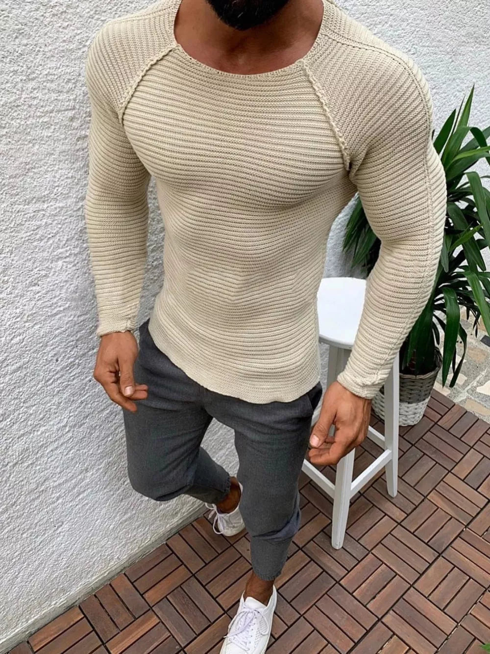 Khaki ribbed knit long sleeve sweater with crew neck and raglan sleeves.