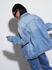 Denim trucker jacket in medium wash with collar and button details.