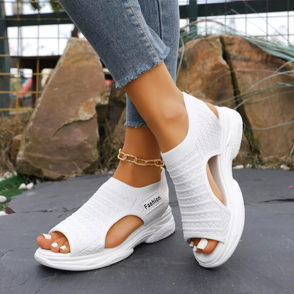 White sporty chunky platform sandals with breathable knit upper and cutout detail.