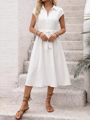 White cap sleeve midi dress with button front, tie waist and A-line skirt.