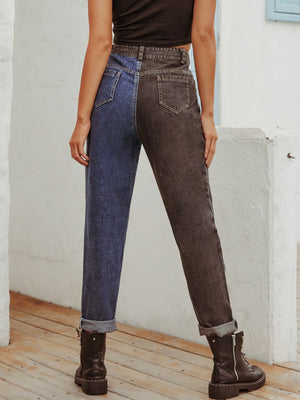 Split-tone straight leg jeans in medium blue and dark grey denim with cuffed hems.