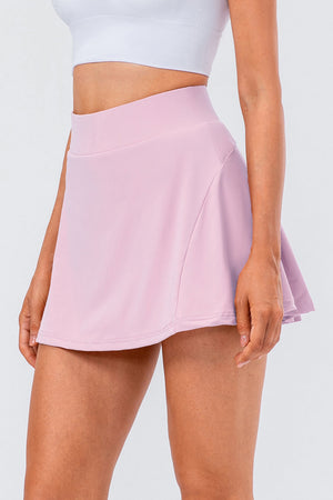 Performance pleated skort in blush pink with a comfortable waistband and athletic cut.