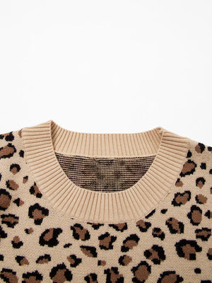 Beige leopard print knit sweater with crew neck and ribbed trim.