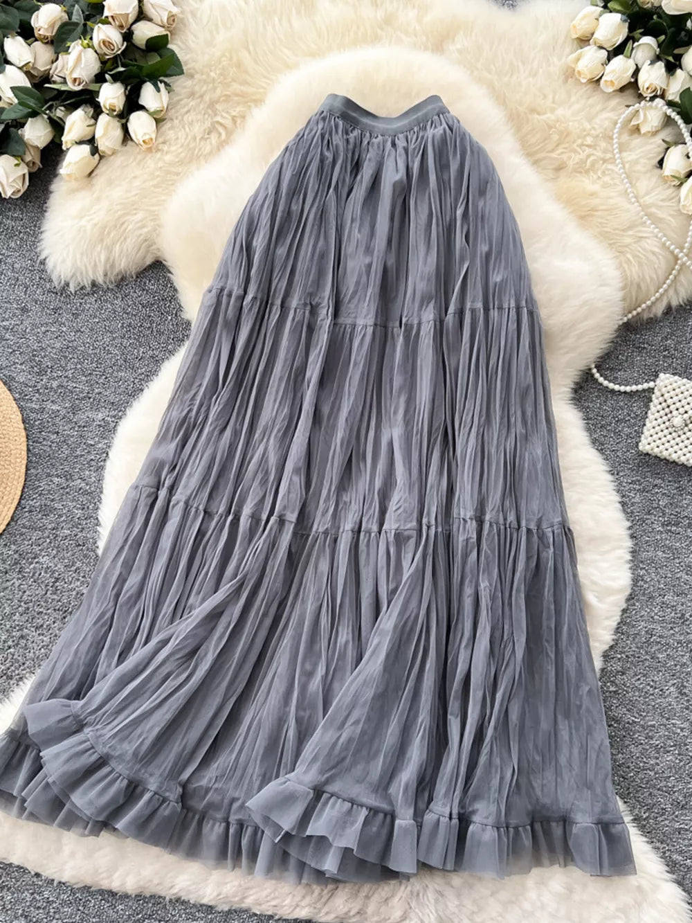 Gray tiered tulle maxi skirt with ruffled hem and lining.