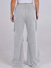 Light gray sweatpants with cargo pockets and wide legs.