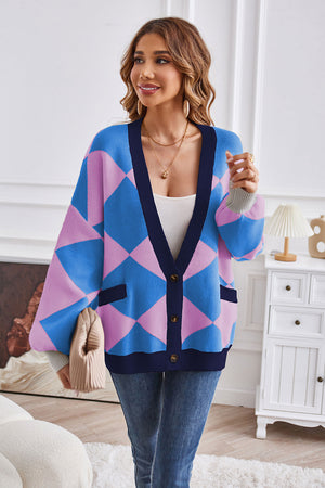 Diamond knit cardigan with balloon sleeves in blue and pink argyle, featuring navy trim and pockets.