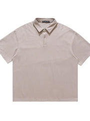 Khaki cotton polo shirt with buttoned collar and short sleeves.